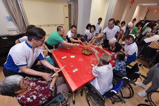Volunteers from the FairPrice supermarket chain celebrating Chinese New Year with the elderly folk at Ren Ci @ Ang Mo Kio nursing home.