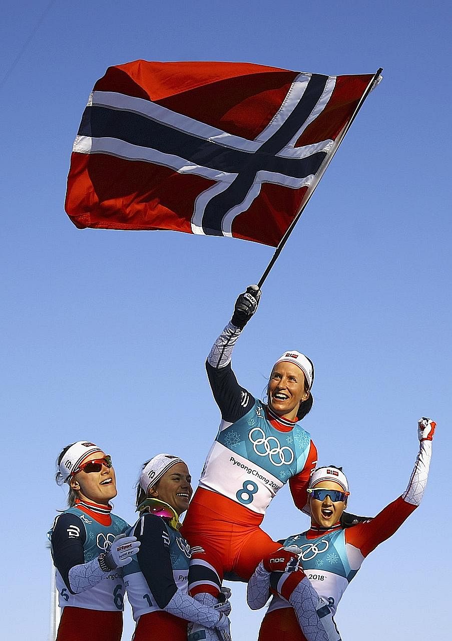 Clockwise, from left: Marit Bjoergen, winner of the 30km cross-country mass start race, being feted while waving the Norwegian flag. Her fifth medal in Pyeongchang took her tally to eight golds, four silvers and three bronzes over five Games - making