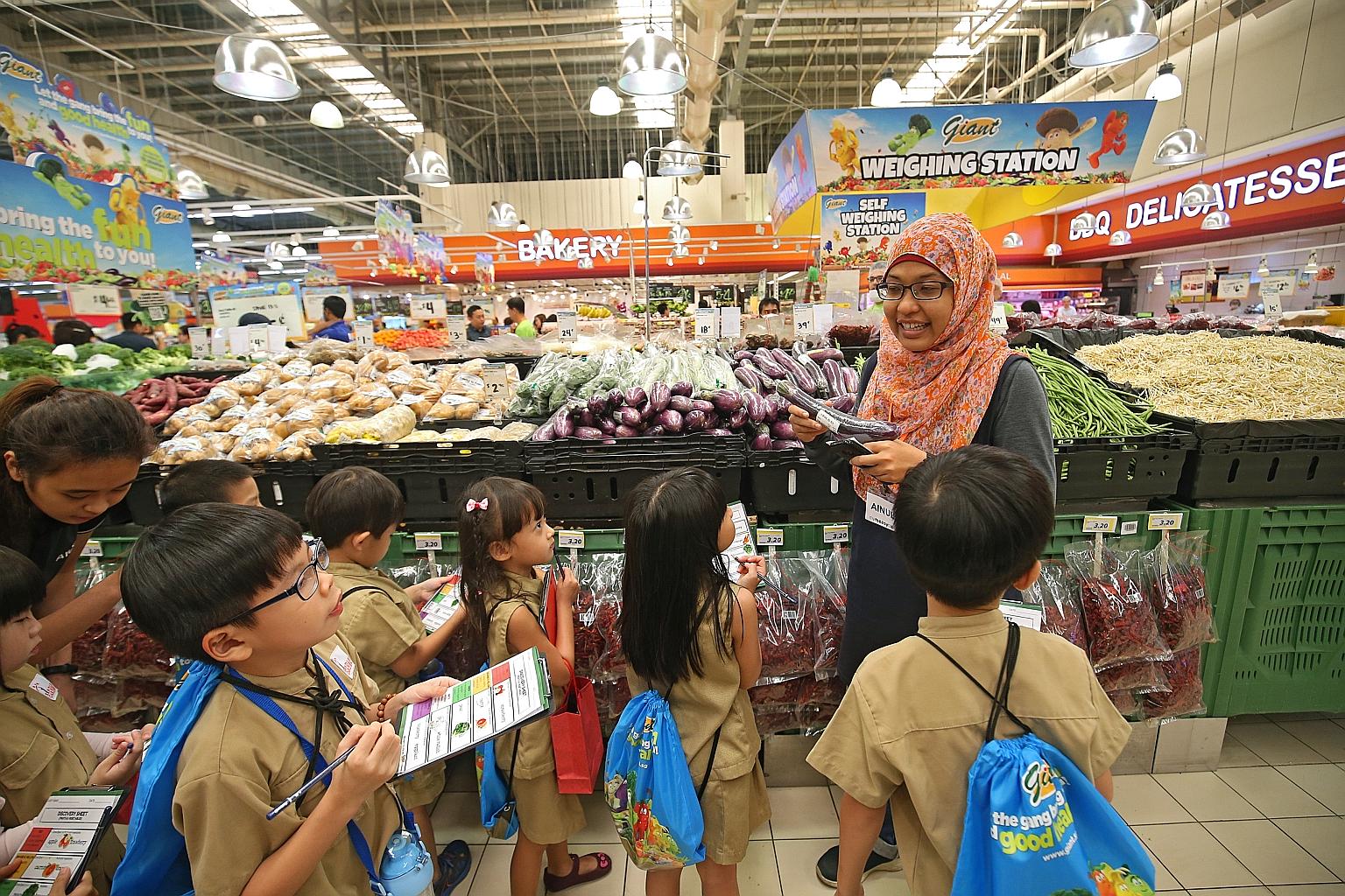 Kindle Garden kindergarten children being taken on an educational tour of Giant supermarket in Tampines by a facilitator from creative educator My Messy Box as part of Giant's Goodness Gang campaign, which aims to get children to eat more healthily.