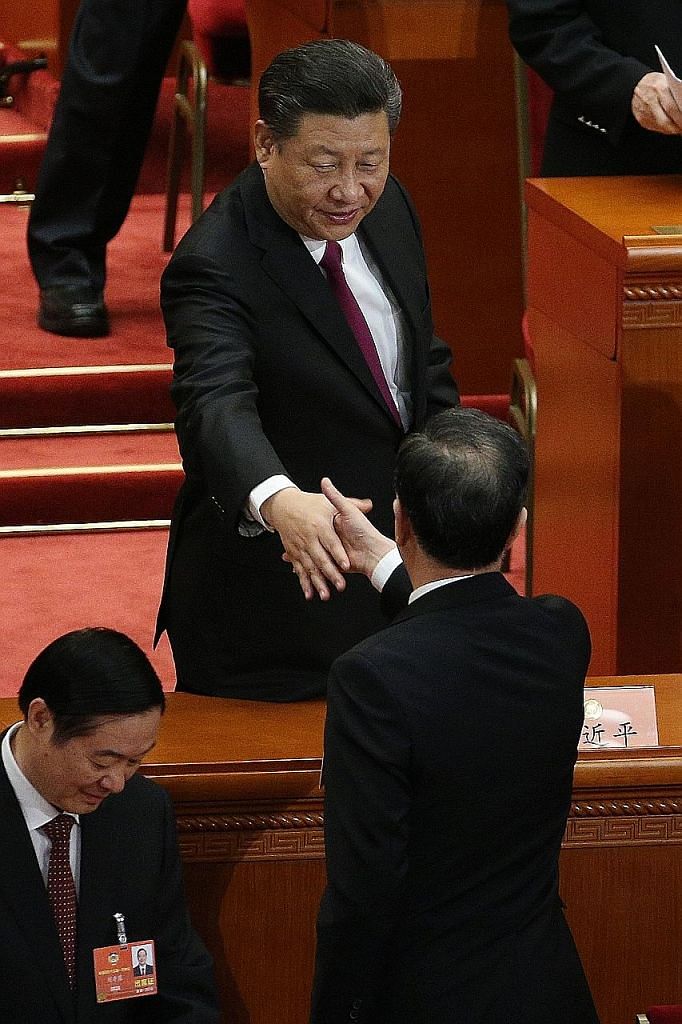 Above: Mr Wang Yang, new head of the CPPCC, said its founding showed China's political parties, sectors of society and nationalities had chosen the CCP's leadership and that 70 years of practice showed this choice was correct. Left: Chinese President
