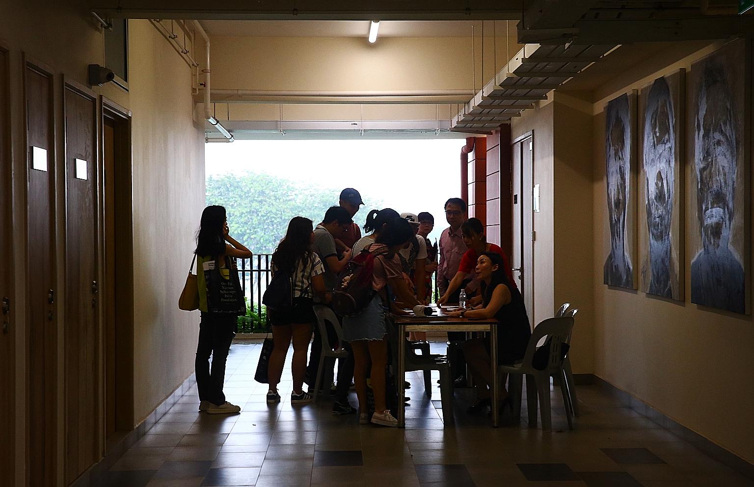 Affected Hwa Chong Institution students checking their names against a register before attending a briefing last month about their missing exam papers.