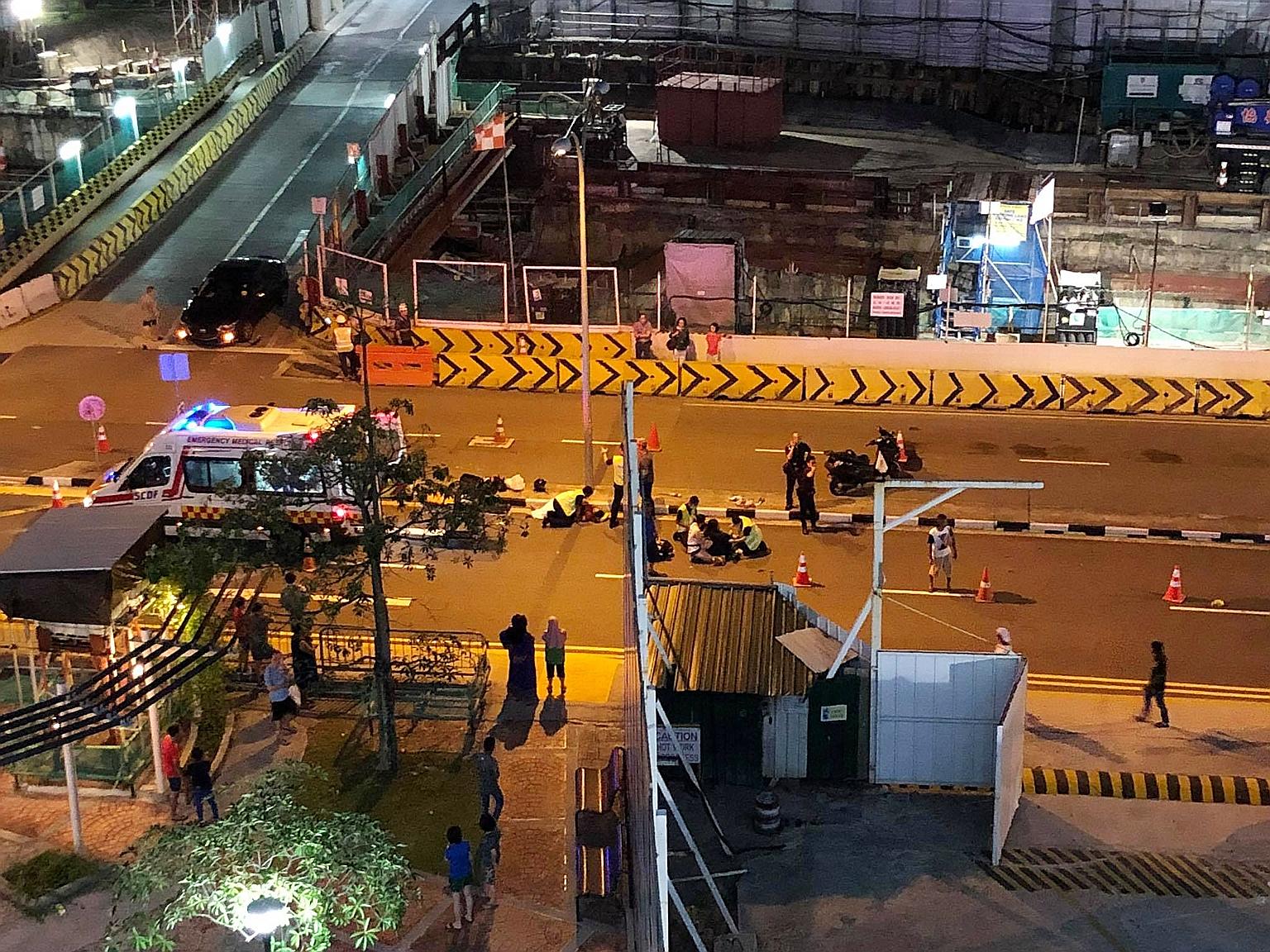 Foreign construction workers directing traffic after an accident involving a car and a motorcycle in Ang Mo Kio Avenue 4 last Saturday night.
