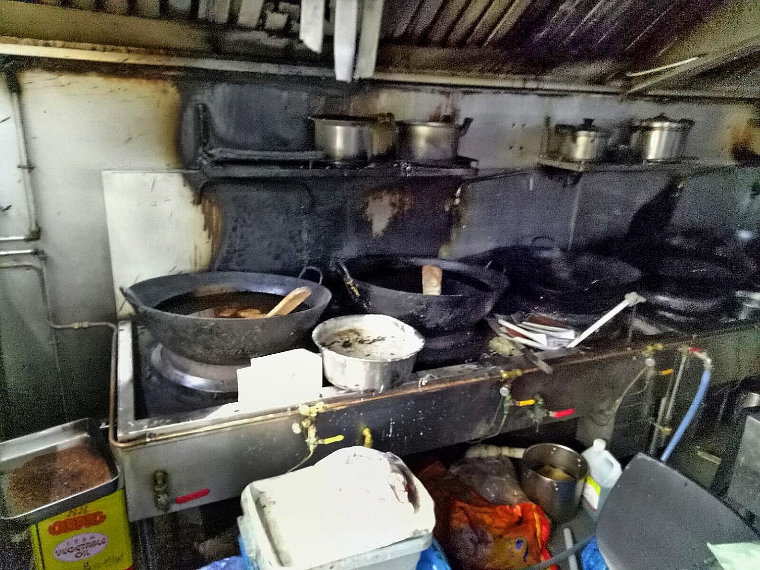 The charred remains of a kitchen at the coffee shop in Yishun where a fire broke out yesterday morning.