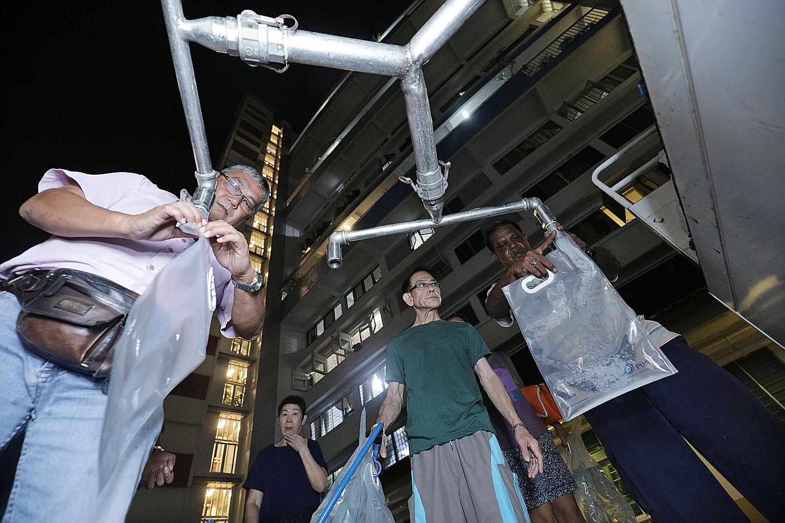 Bendemeer Road residents queueing to collect clean water on Tuesday night. PUB said it had isolated the section of the pipe where the mineral resuspension occurred and tapped an alternative feed to supply water to affected blocks. The discoloured wat
