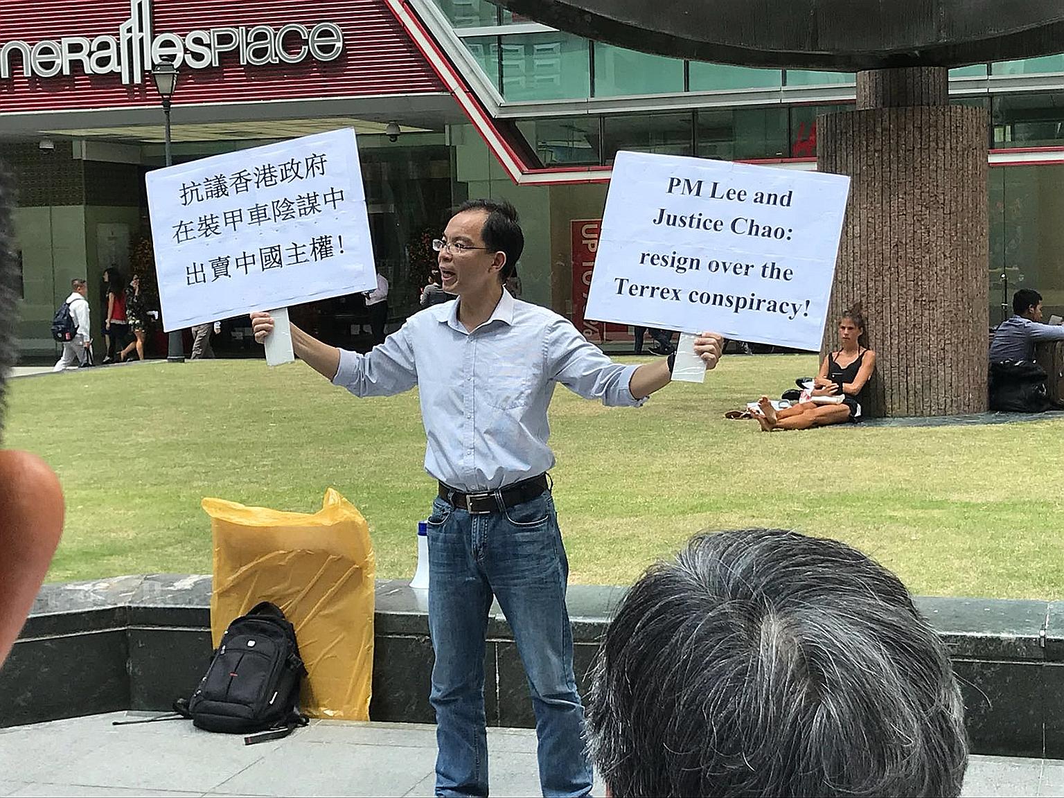 Yan Jun was seen holding placards while addressing the lunchtime crowd outside Raffles Place MRT station on Feb 22.
