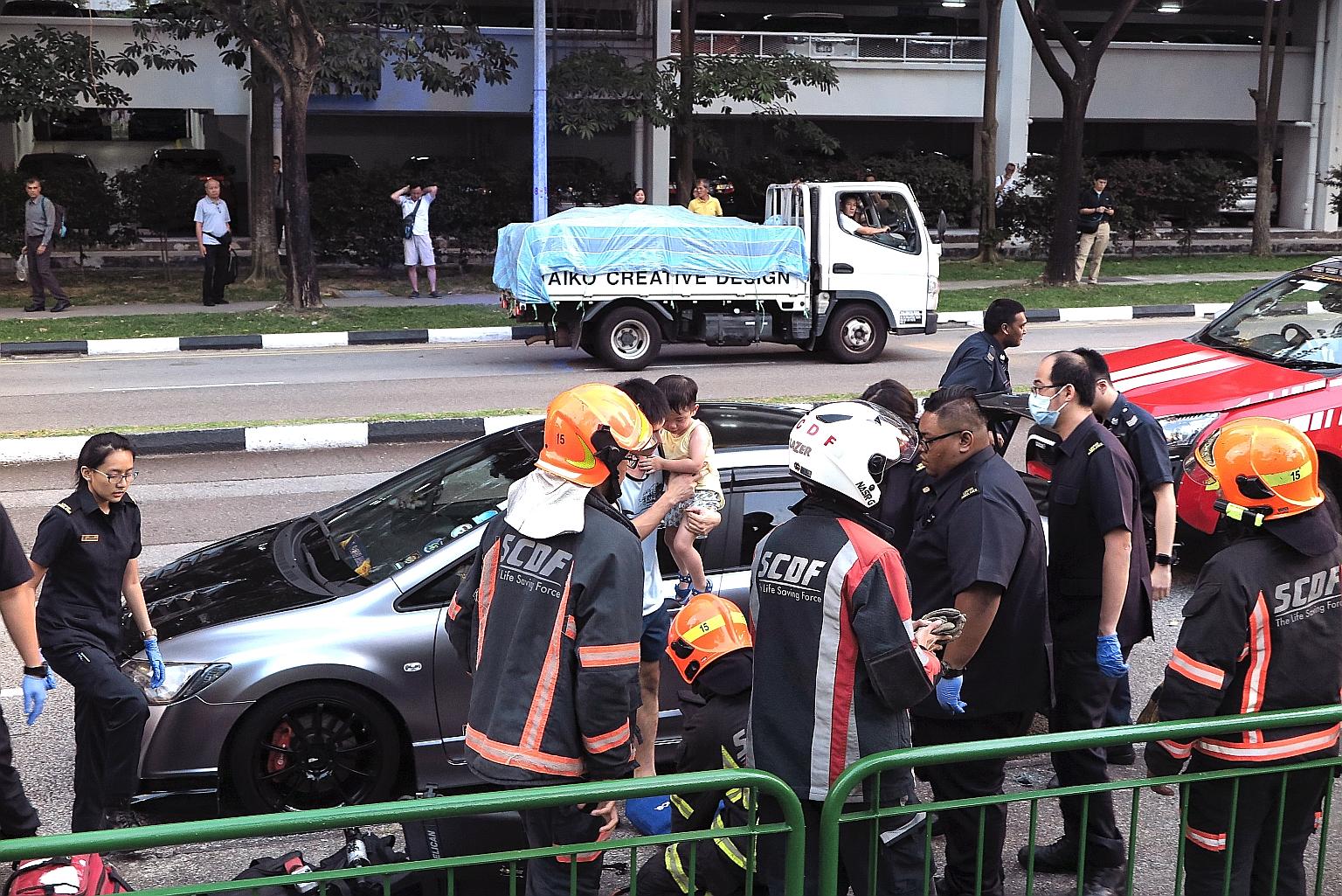 The boy with his father after being rescued on Wednesday evening. The father had reportedly got out of the car to pick something up from the left passenger seat. But before that, he handed the car key to his son, who was in a child seat. Just as he s