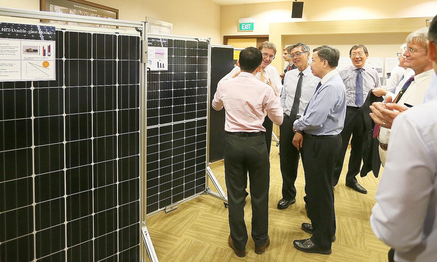 Guests viewing an exhibition at the National University of Singapore Shaw Foundation Alumni House to mark the Solar Energy Research Institute of Singapore's 10th anniversary. The institute has had several breakthroughs under its belt, said its chief,