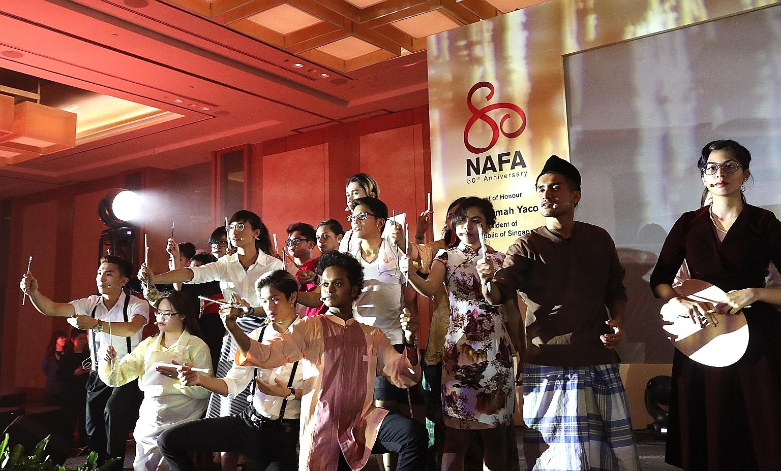 Students performing in a play at the Nanyang Academy of Fine Arts' 80th anniversary celebration gala dinner at Marina Bay Sands yesterday. It was attended by 700 people, including President Halimah Yacob.