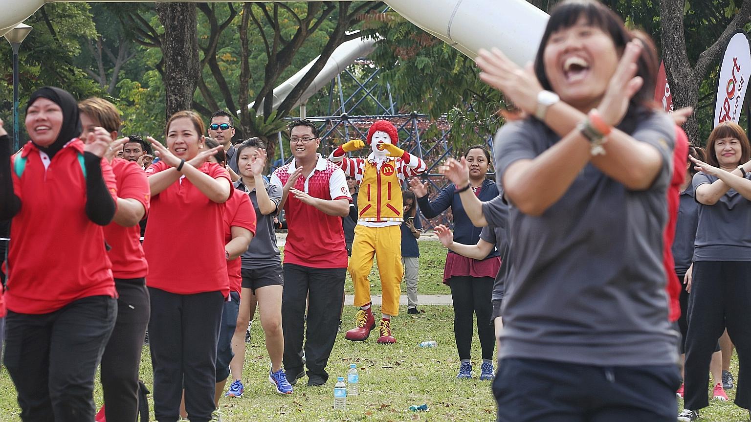 More than 100 McDonald's employees taking part in a mass workout session at West Coast Park yesterday morning. McDonald's is GetActive Singapore's first partner for this year, and plans to hold family-targeted fitness sessions at several of its outle
