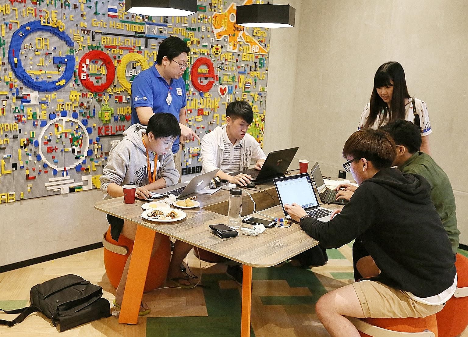 Tertiary students working to come up with ideas to improve the fact-checking process at a fake news hackathon last year organised by the National University of Singapore, Singapore University of Technology and Design, Google and the Media Literacy Co