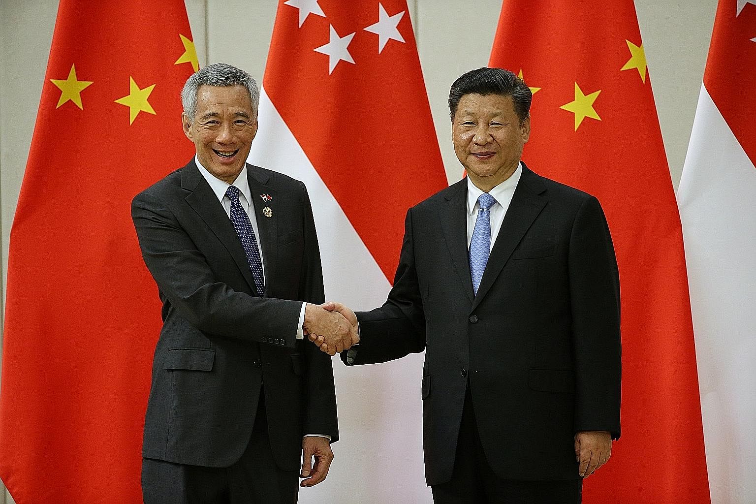 Prime Minister Lee Hsien Loong with Chinese President Xi Jinping at the Boao Forum on Tuesday. Mr Lee says in his speech that China's role in the international economy will grow larger. This has shifted the overall strategic balance. It has also rais