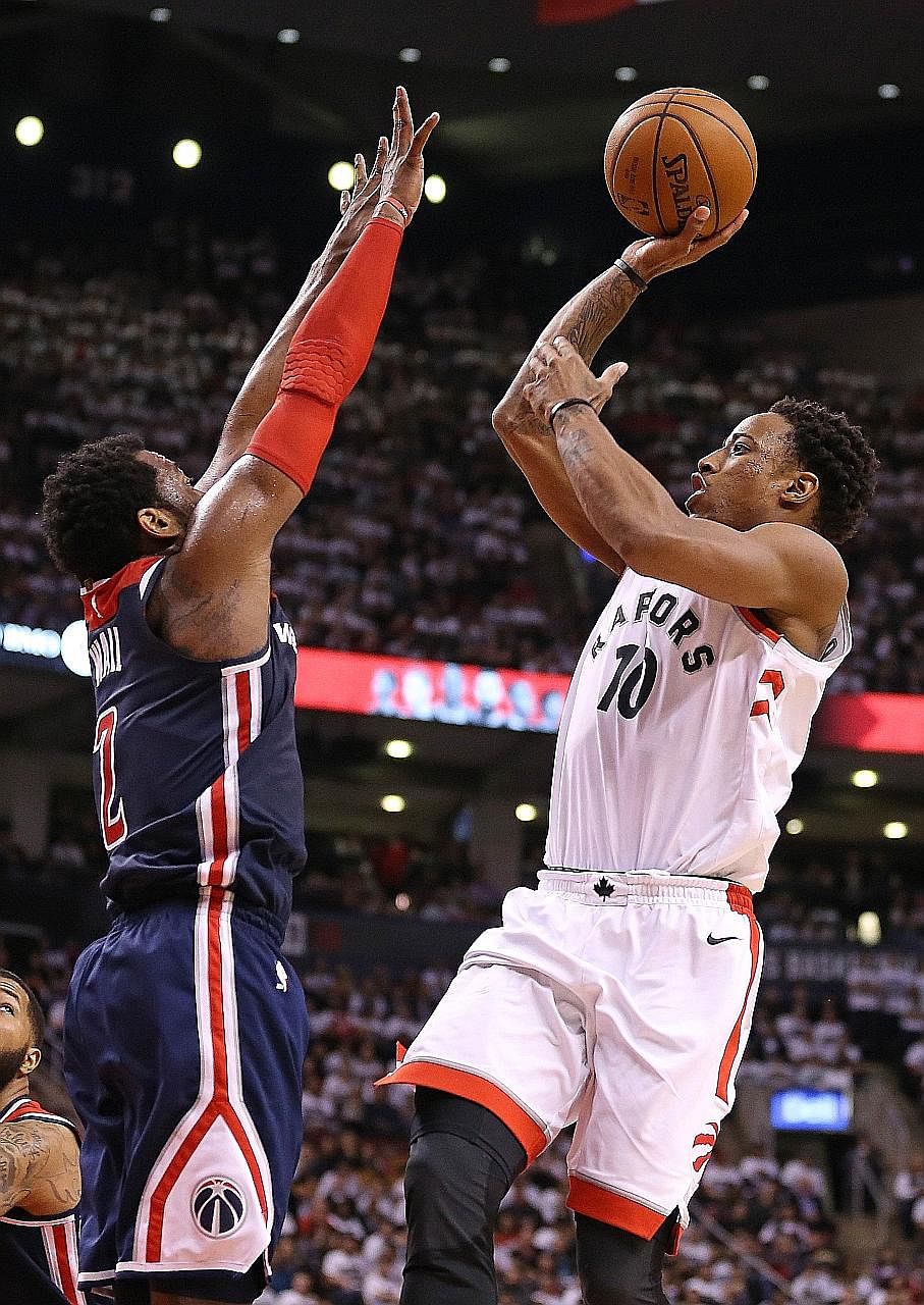 DeMar DeRozan of the Toronto Raptors going up for a shot over the Washington Wizards' John Wall in Game 2 of the Eastern Conference first-round play-offs at the Air Canada Centre. The Raptors defeated the Wizards 130-119 with DeRozan matching his pla