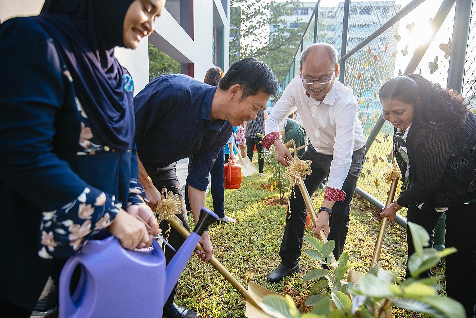 Planting trees to observeEarth Day at Juying Primary yesterday were (from left) Madam Rahimah Jaffar, chairman of the school's Parent Support Group; Mr Lee Seng Hai, superintendent of schools, Cluster West 3; Mr Yee Chia Hsing, an MP for Chua Chu Kan