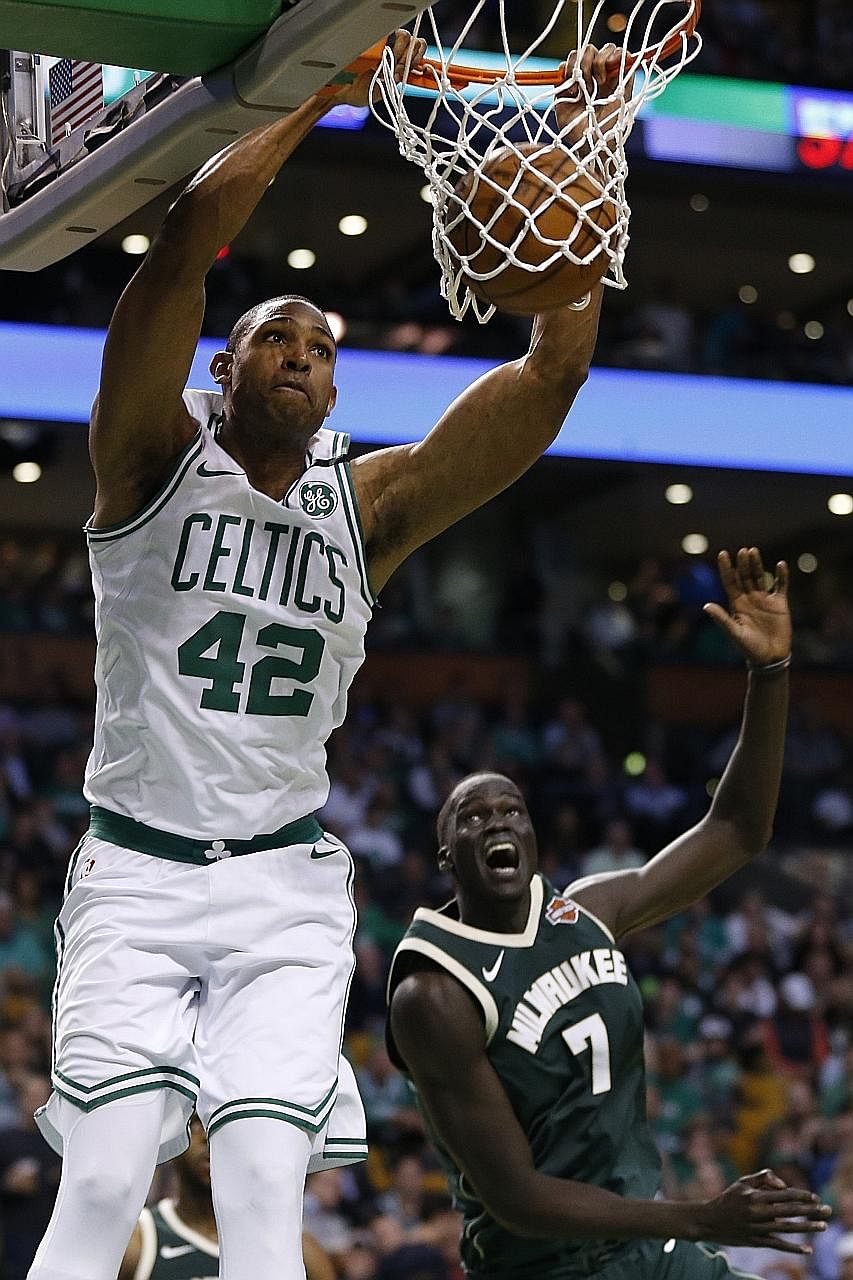 Boston Celtics forward Al Horford dunking the ball during the third quarter as Milwaukee Bucks centre Thon Maker comes off second best in this play in Game 7 of the NBA first-round play-offs at TD Garden.