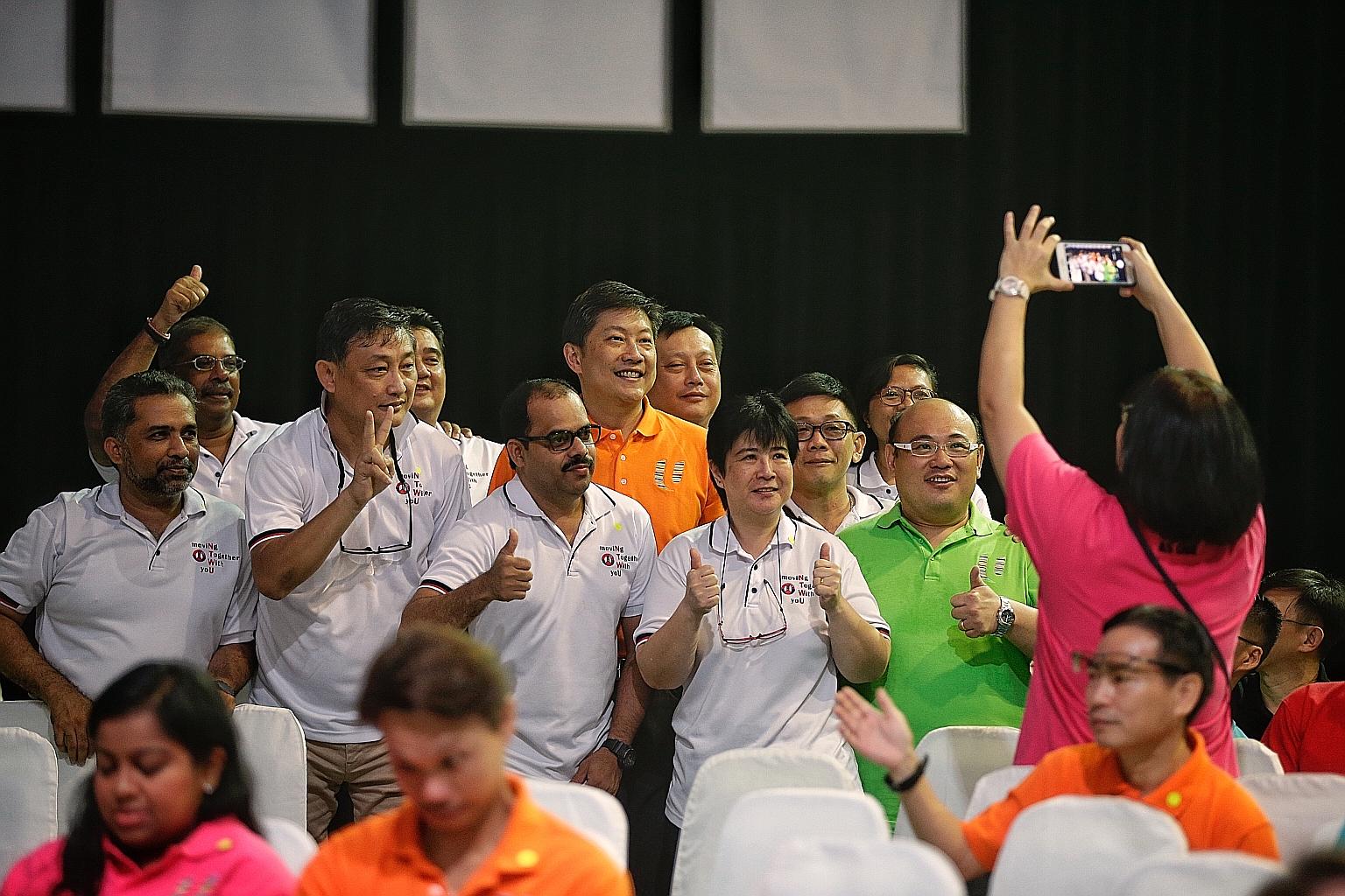 NTUC deputy secretary-general Ng Chee Meng (in orange) with rally participants at Downtown East yesterday. He had worked closely with the teachers' and transport workers' unions before his new appointment.