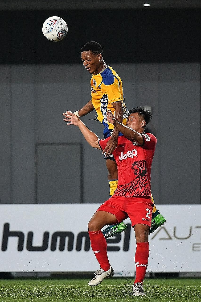 Above: Tampines defender Irfan Najeeb scored his first Singapore Premier League goal in the 49th minute when he headed in a Safirul Sulaiman cross yesterday. Right: Tampines forward Jordan Webb rising above Balestier defender Muhammad Fadli Kamis at 