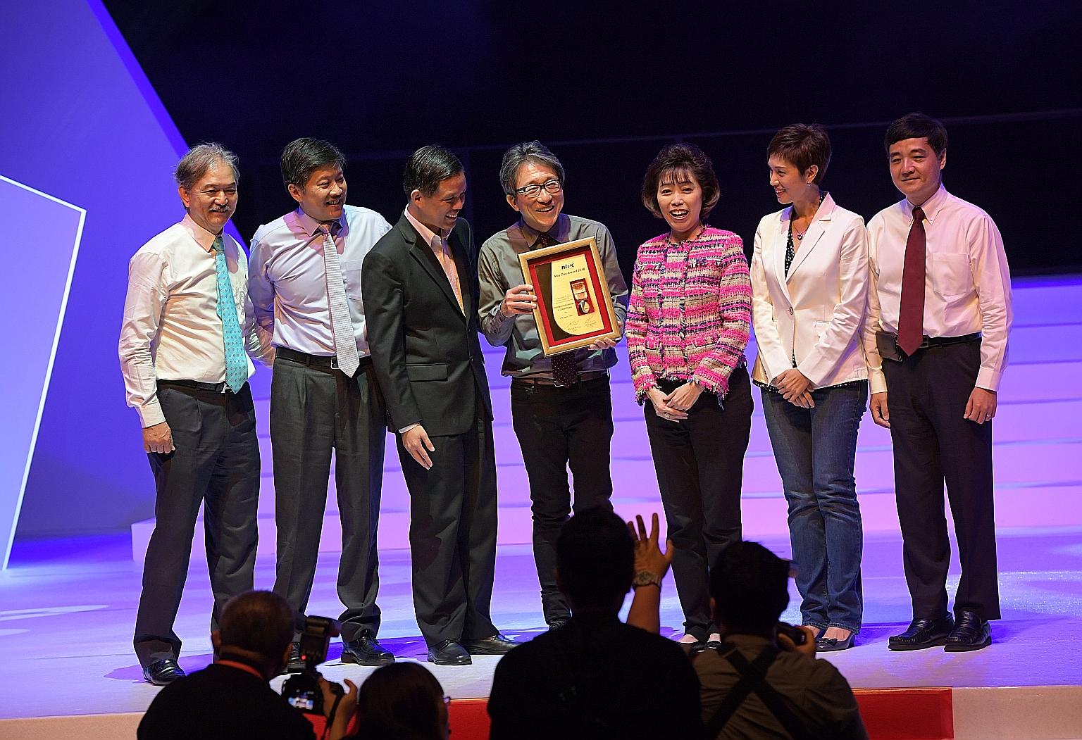 Former manpower minister Lim Swee Say with his Distinguished Comrade of Labour award at the May Day Awards ceremony yesterday. With him are (from left) Singapore National Employers Federation president Robert Yap, NTUC deputy secretary-general Ng Che