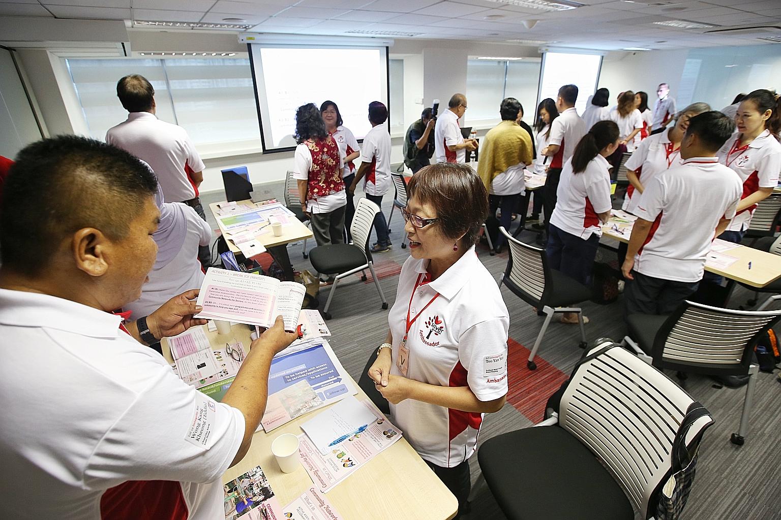 Mr Eddie Wong and Madam Teo Yan Yan role playing during training for SG Ambassadors at the newly launched training facility in the Silver Generation Office. The volunteers must undergo 12 hours of classroom training.