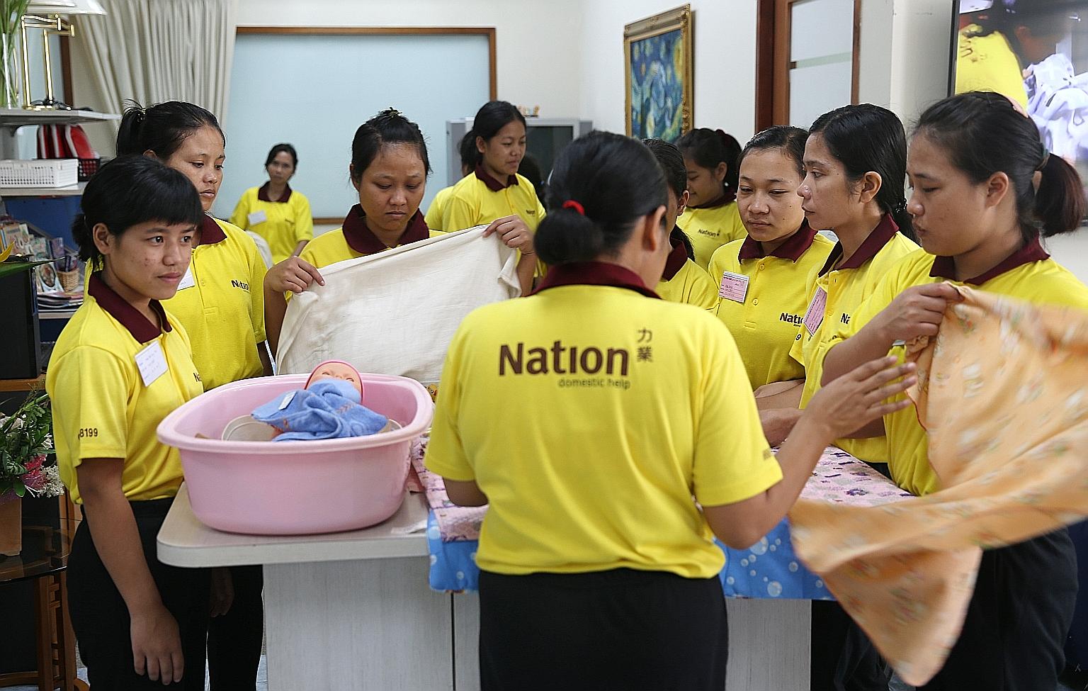 Maids being trained at an employment agency here. The new performance bond of $6,000 imposed by the Indonesian Embassy on employers here who hire maids from Indonesia took effect last month.
