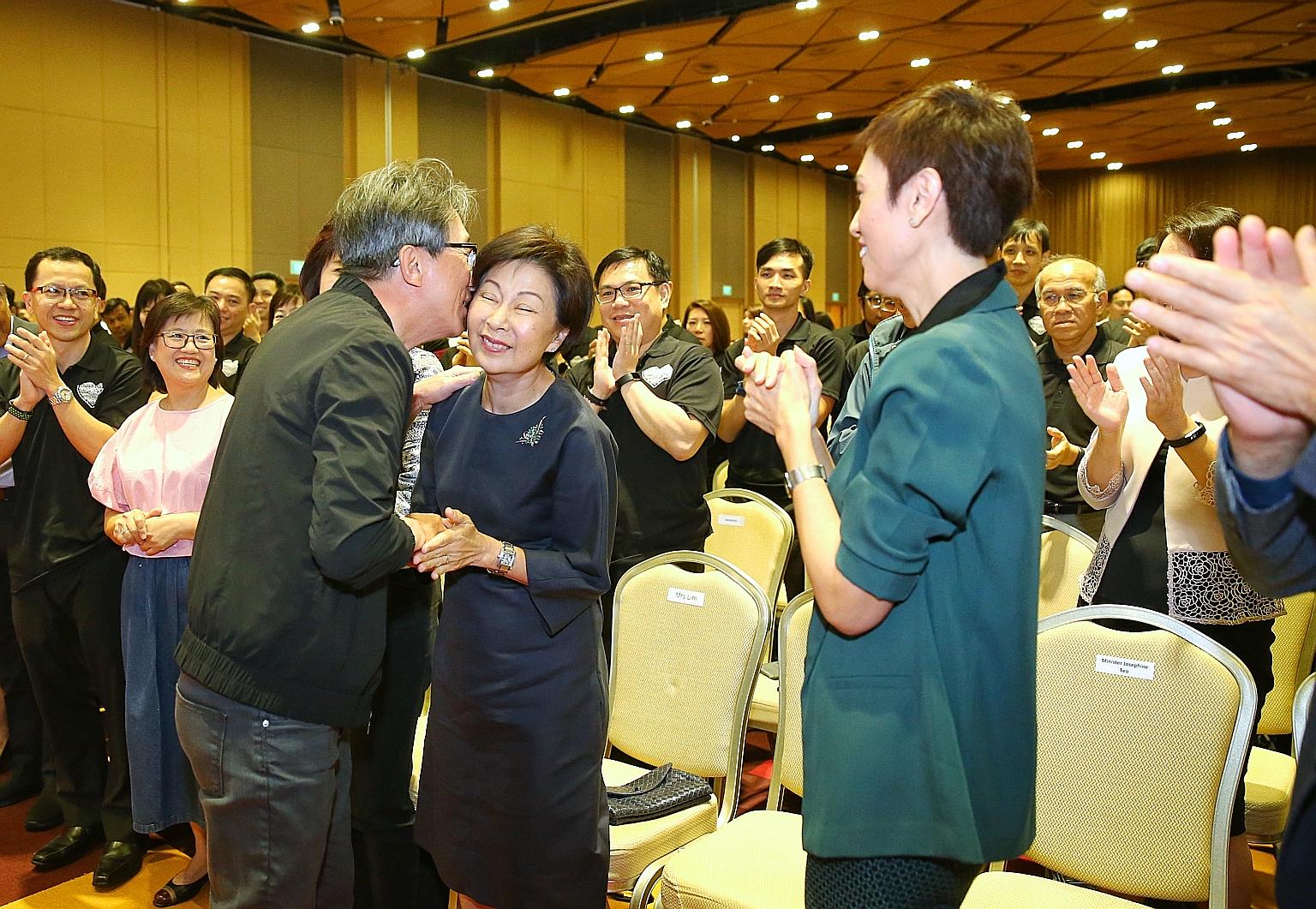 Right: Former manpower minister Lim Swee Say holding a miniature figure of himself that was presented to him. Far right: Mr Lim kisses his wife after giving a speech, as current Manpower Minister Josephine Teo looks on.