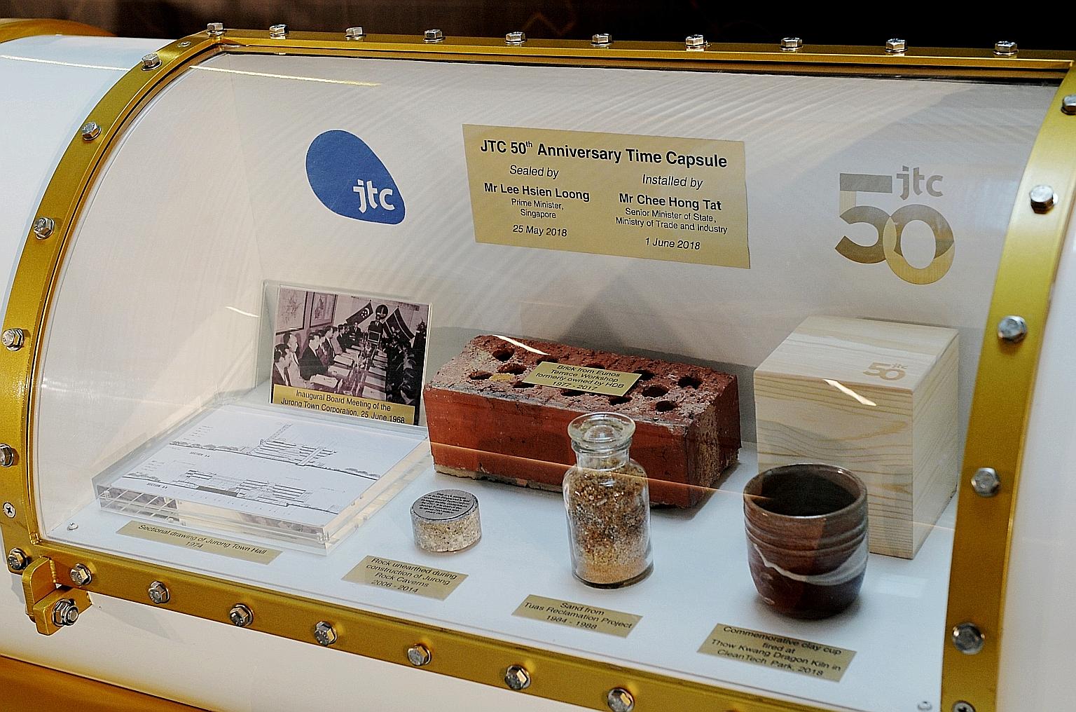 Items inside the time capsule to mark JTC's 50th anniversary include a bottle of sand from JTC's Tuas Reclamation Project and samples of materials used to construct JTC LaunchPad @ one-north.
