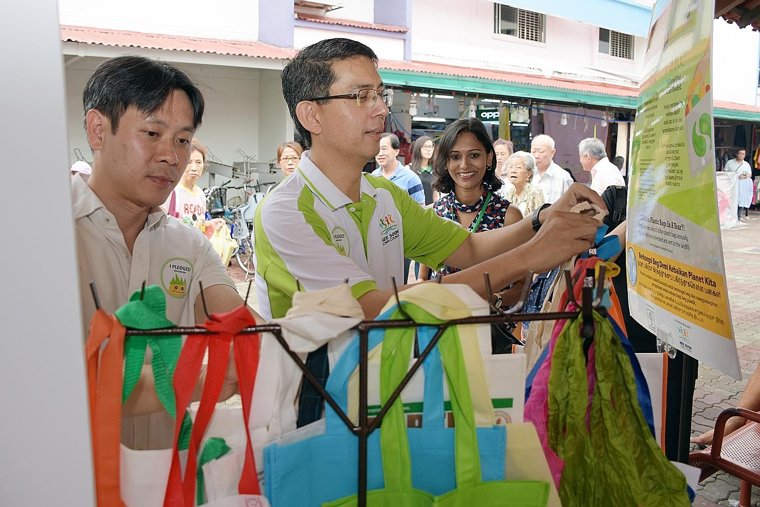 Nee Soon GRC MPs Louis Ng (left) and Faishal Ibrahim at the launch of Bounce Bags, which makes available shopping bags, such as fabric tote bags, at a designated sharing point for residents. Next to them is Ms Aarti Giri, founder of Plastic-Lite Sing
