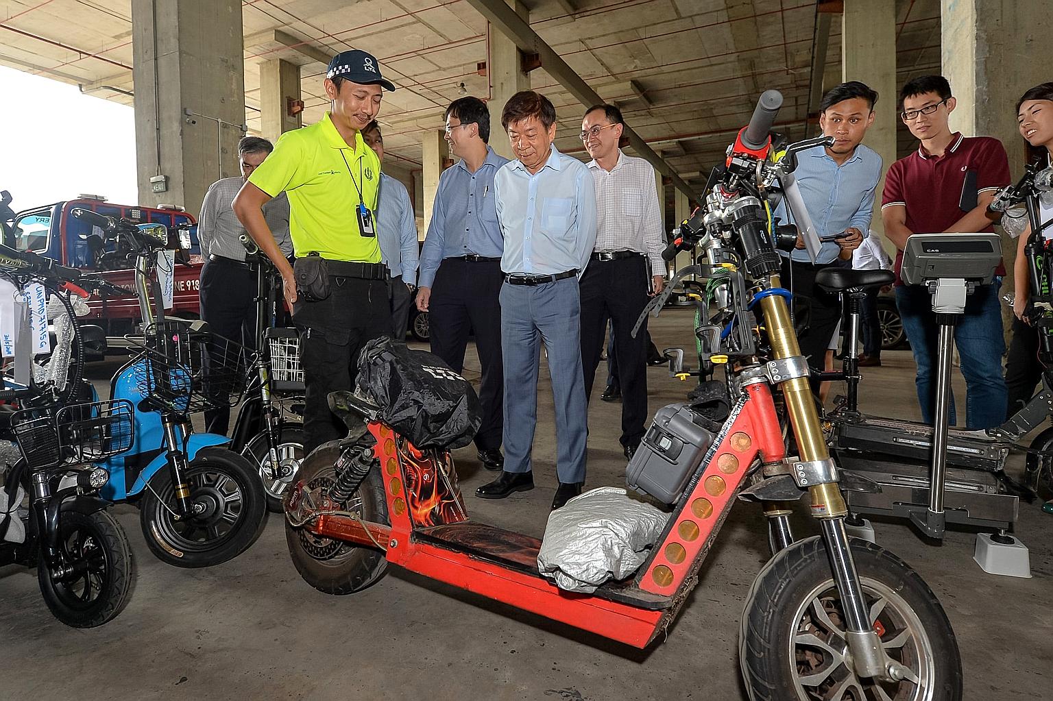 Transport Minister Khaw Boon Wan taking a look at the seized 92kg e-scooter during a visit to the LTA pound. The maximum weight allowed is 20kg.
