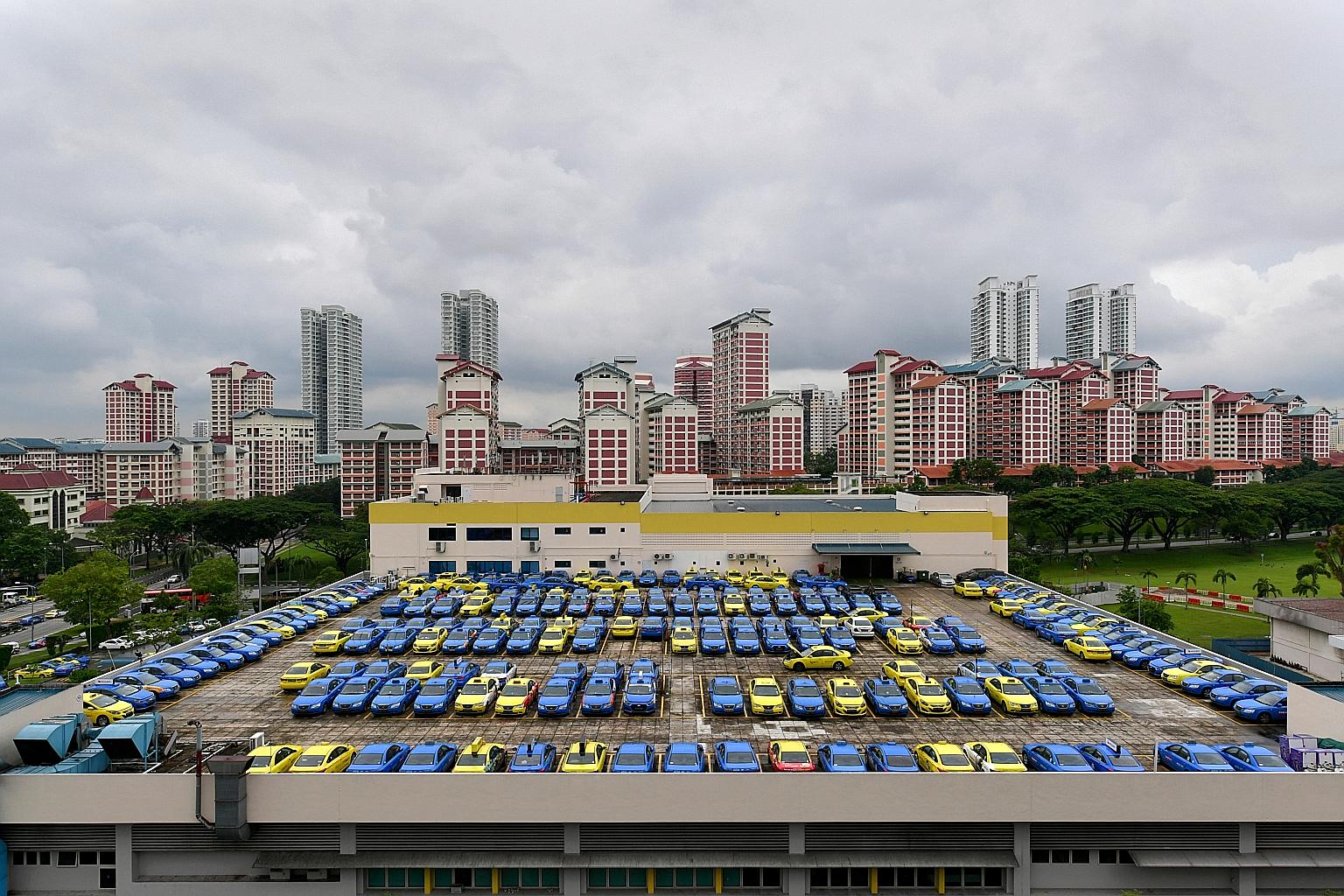 Comfort and CityCab vehicles parked at the CityCab Building in Sin Ming Avenue. Last month, ComfortDelGro called a tender for the supply of 500 more taxis - just a week after it announced that it had bought 200 new cabs, its first purchase in 18 mont