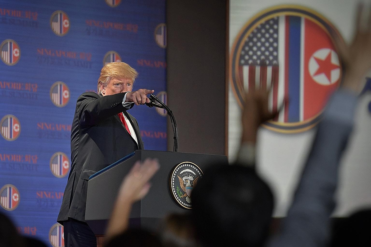 US President Donald Trump speaking to the media after the summit yesterday. In the joint statement, Mr Trump "committed to provide security guarantees" to North Korea, and Mr Kim Jong Un "reaffirmed his firm and unwavering commitment to complete denu