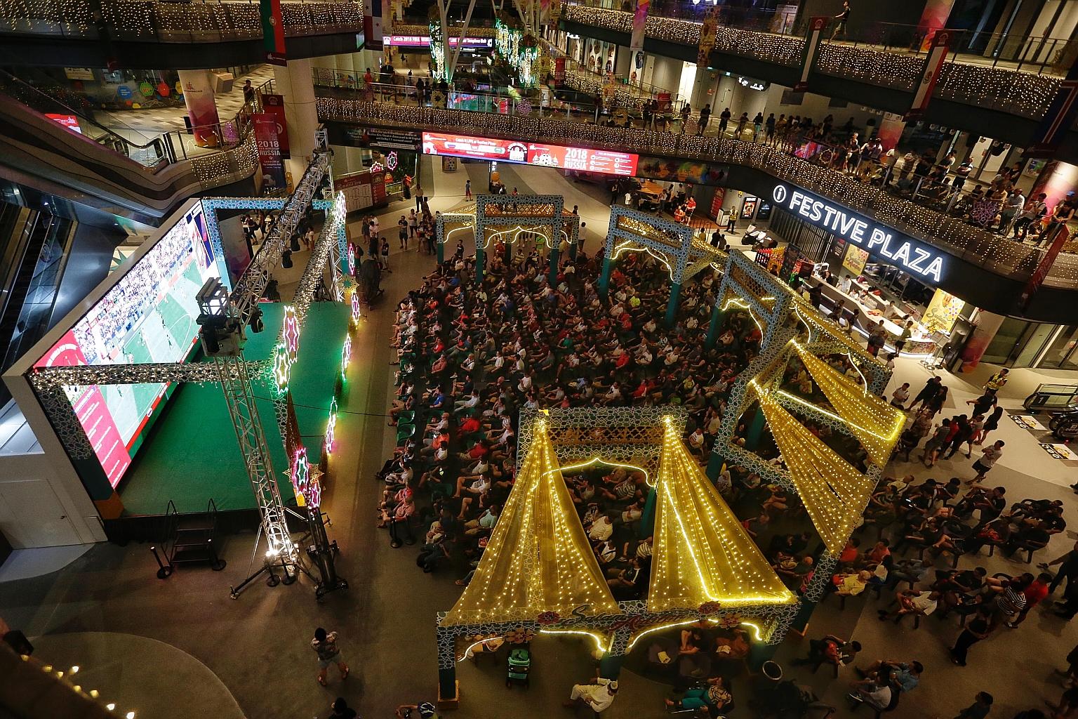 Football fans catching the live telecast of the opening match between Saudia Arabia and host nation Russia at Our Tampines Hub last night. It will be screening all 64 matches of the month-long World Cup tournament for free.