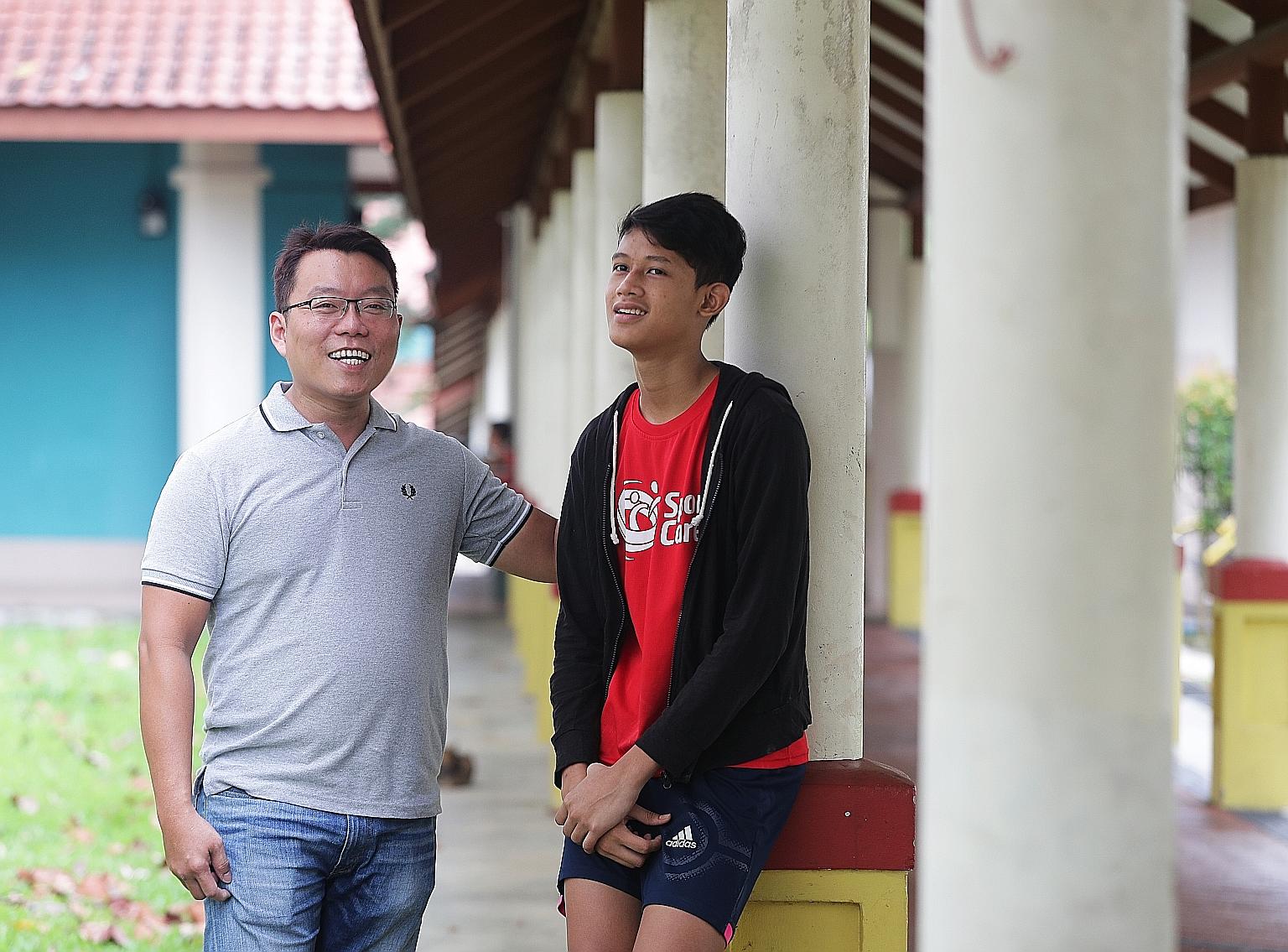 Mr Siow Peng Guan with 16-year-old Ali Imran Rosli, whom he mentors at charity Tasek Jurong's Beacon of Life Academy, at the block of flats in Taman Jurong where the teenager lives.