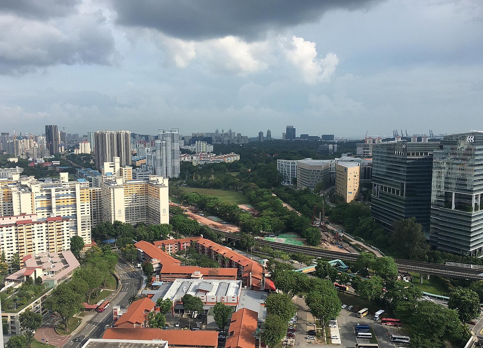 Above: The five-room HDB resale flat sold for $1.1 million is on the 38th floor of Block 18C in Holland Drive. Left: The view from the 38th floor of Block 18C.