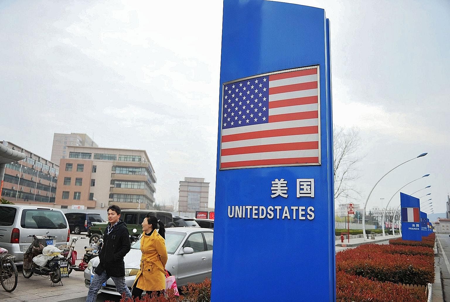 Far left: Harley-Davidson motorcycle engines being assembled at the firm's plant in Wisconsin. The bikes are the target of EU tariffs. The US flag seen outside a supermarket selling foreign goods in Qingdao in China's eastern Shandong province. China