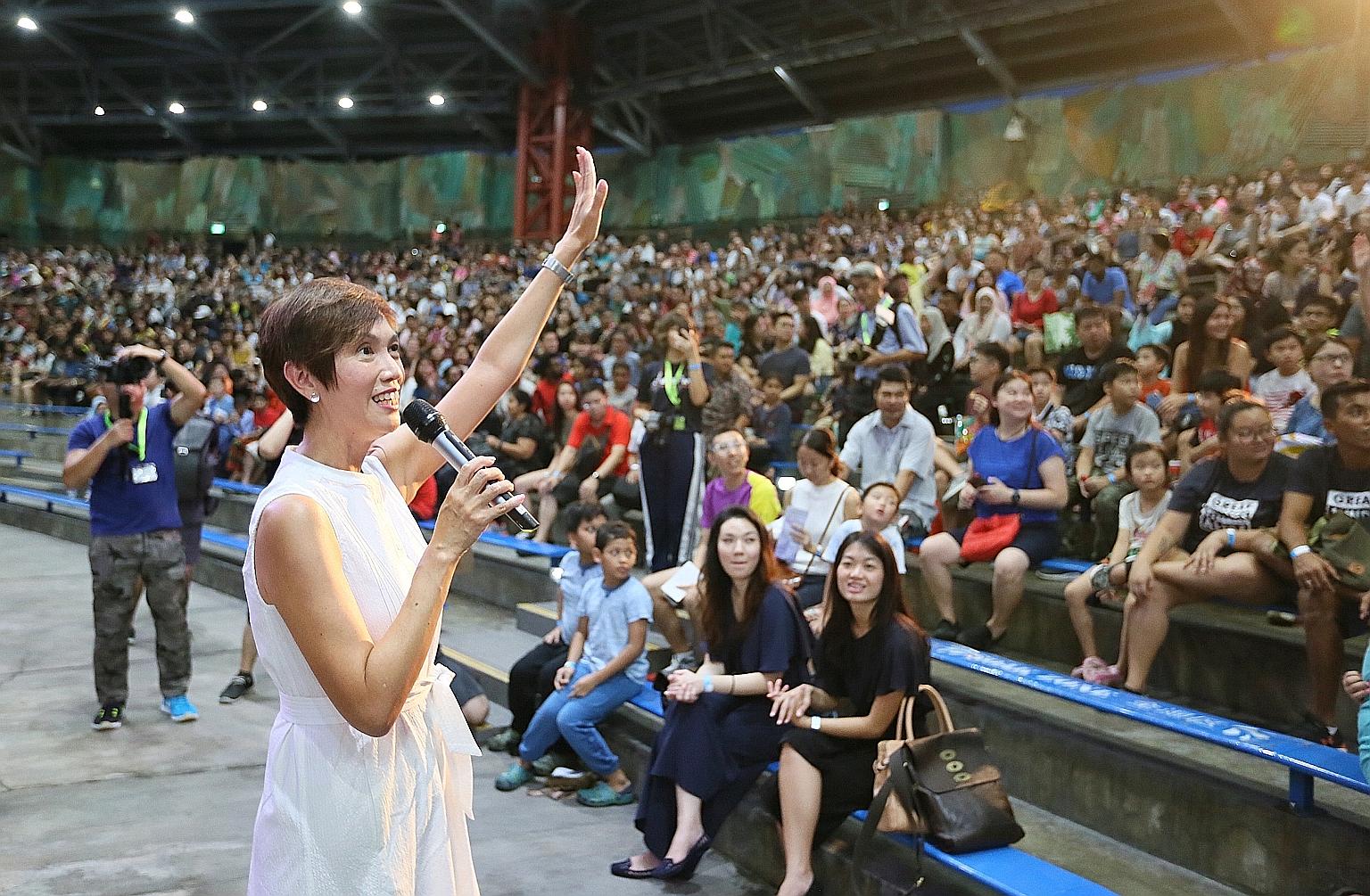 HomeTeamNS president Josephine Teo, who is Manpower Minister, speaking to some 5,000 HomeTeamNS members, volunteers and their families at the inaugural family day event at Universal Studios yesterday.