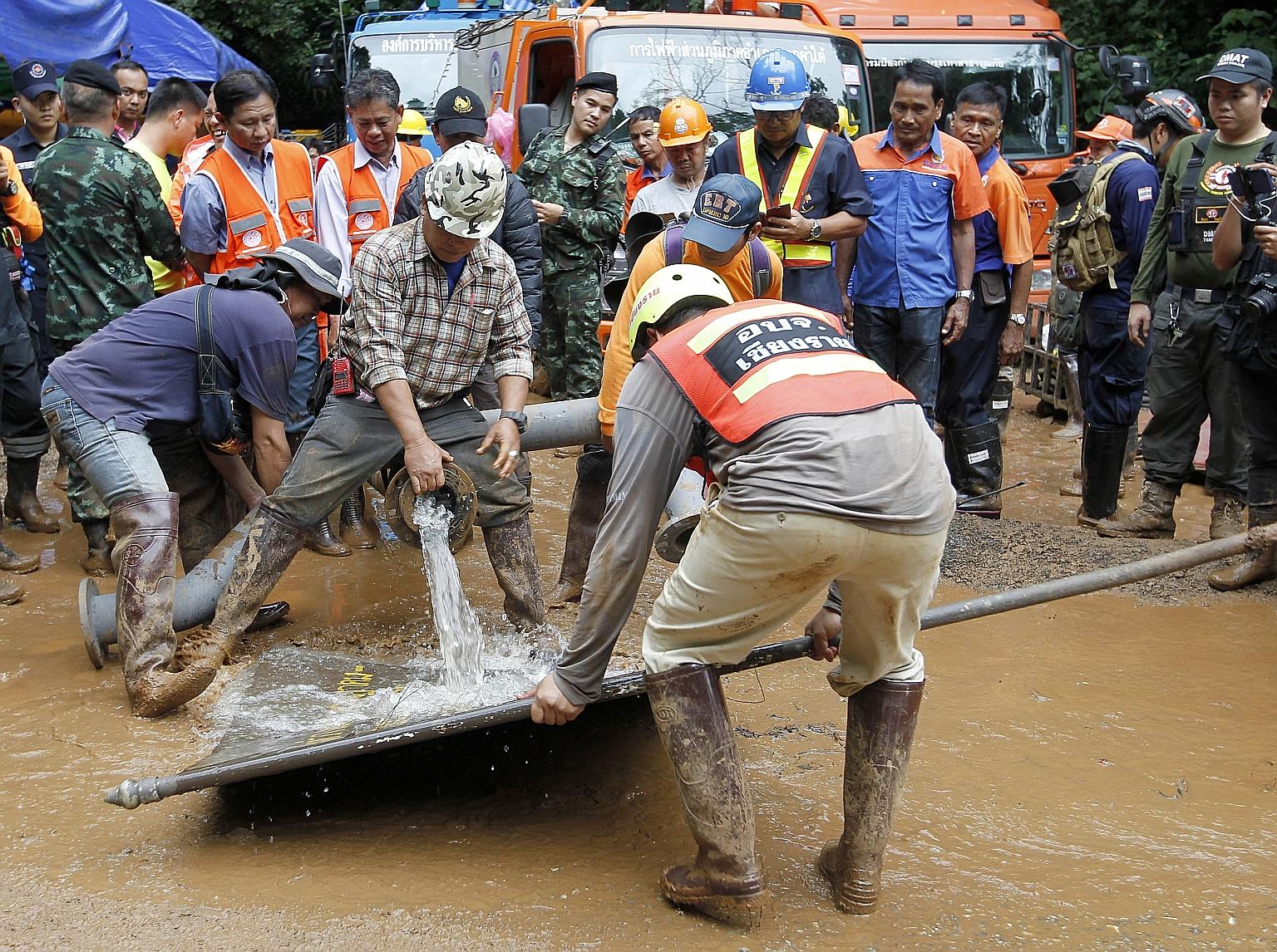 Workers yesterday pumped water out of a flooded cave in Thailand, where 12 boys and their football coach are said to be trapped.
