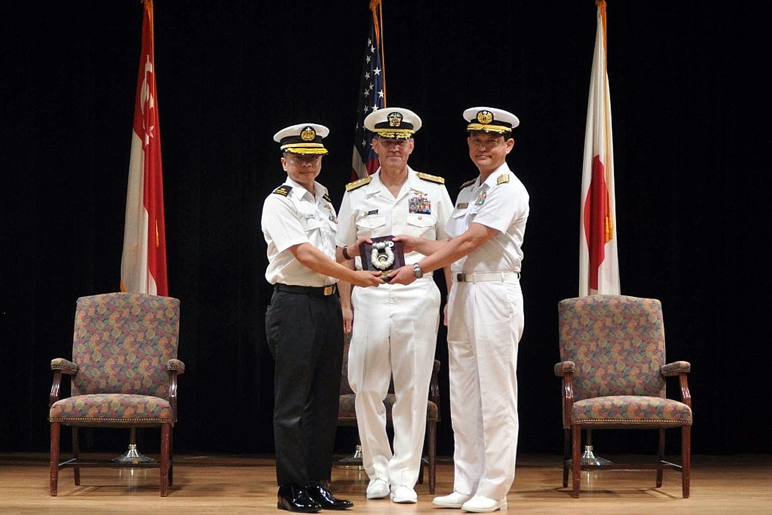Rear-Admiral Saw Shi Tat (left) taking over command of Combined Task Force 151 from Rear-Admiral Daisuke Kajimoto of Japan, witnessed by Vice-Admiral Scott A. Stearney, Commander of the Combined Maritime Forces, at the change of command ceremony in B