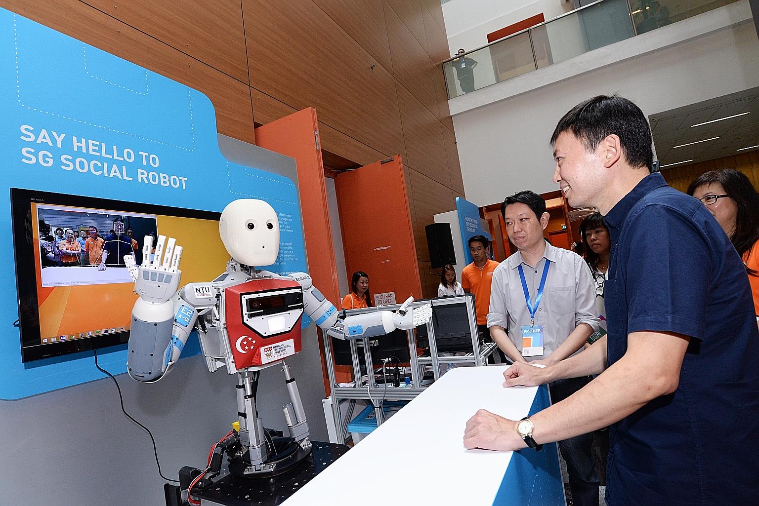 Senior Minister of State Chee Hong Tat viewing a demonstration by one of the exhibitors at the SkillsFuture Festival yesterday.