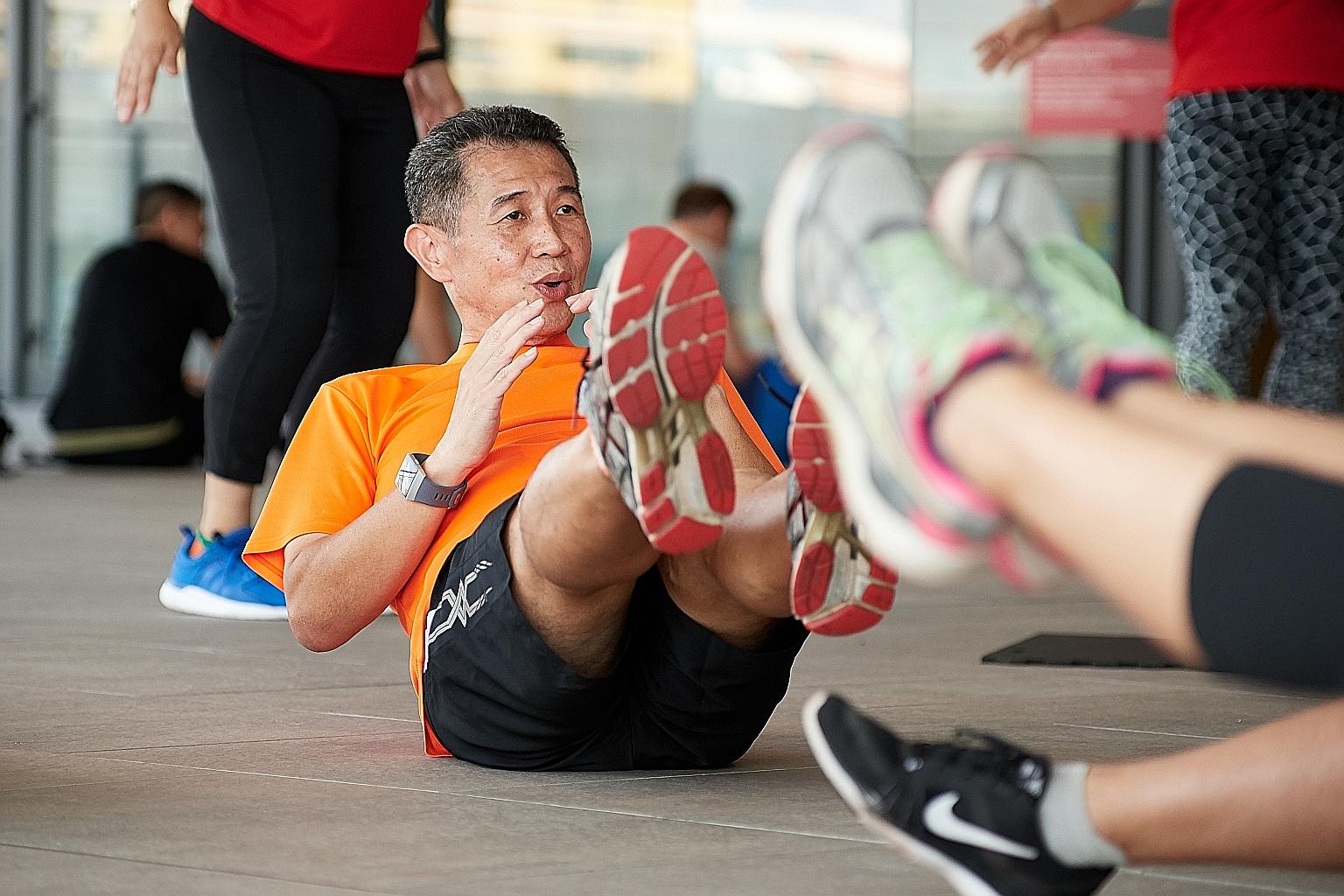 Mr Edmund Yu leading his group in exercises during a "boot camp" session held at Our Tampines Hub on May 5. The senior project manager became inspired to help others lose weight after he shed more than 10kg off his 91kg frame. This was achieved after