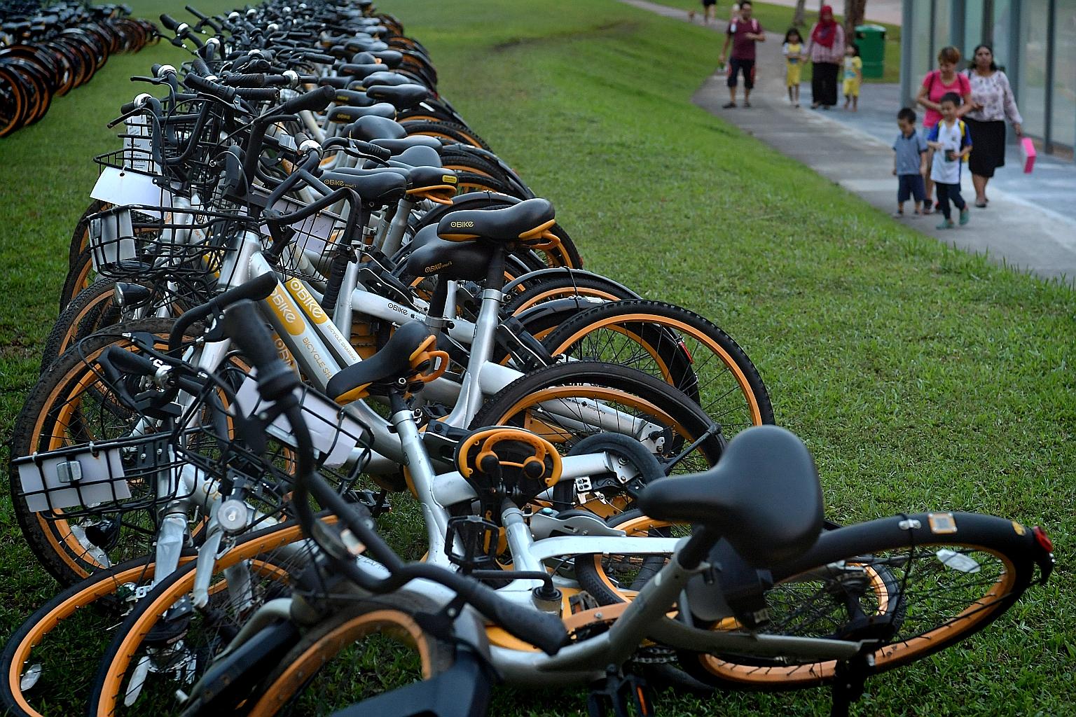 Rows of oBikes in a field in Sengkang yesterday evening. Mr Shi Yi said the firm would not be able to clear all its bikes by yesterday's deadline and was likely to need an extension.