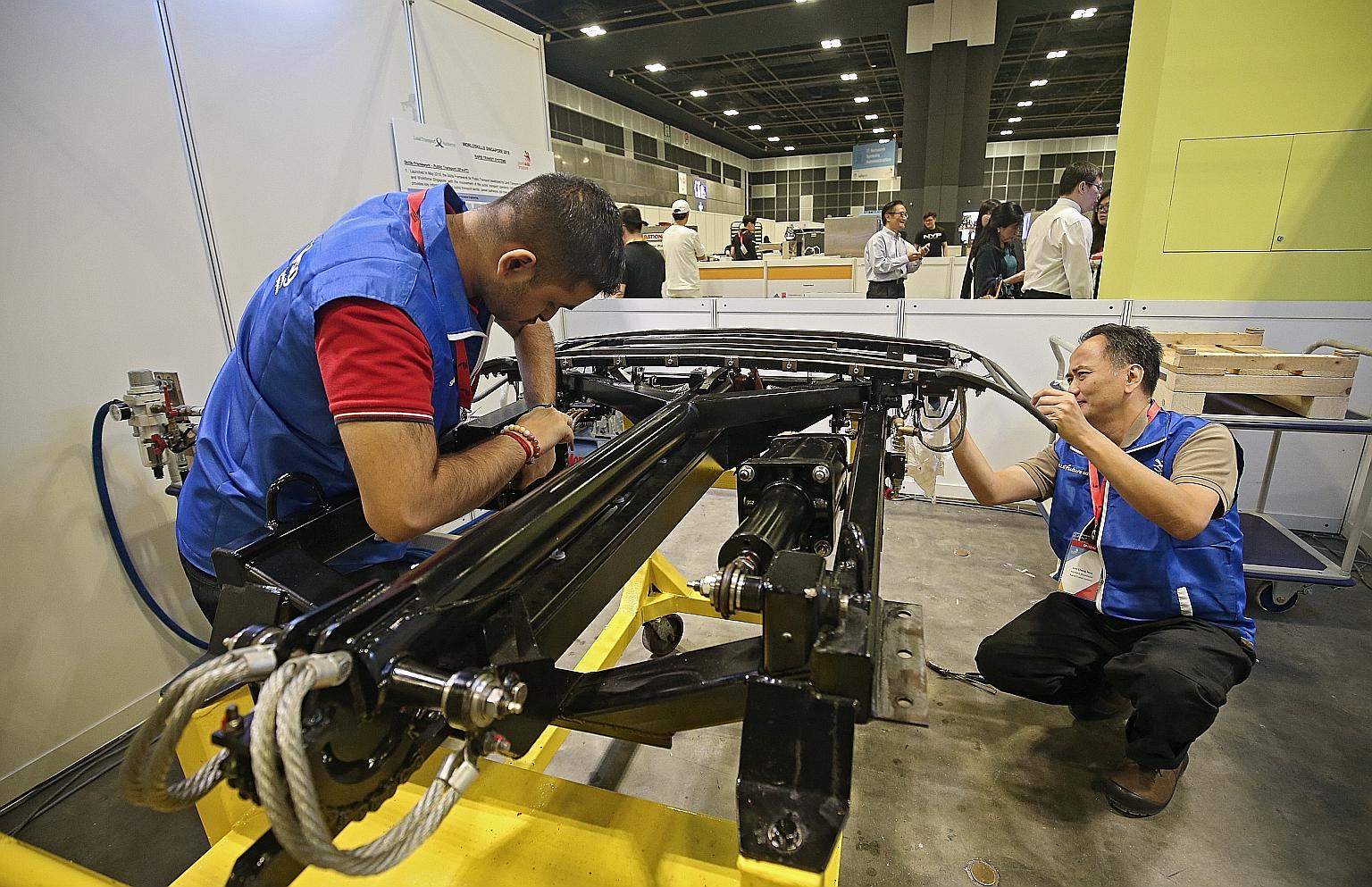 Experts from the rapid transit systems skill area checking equipment required for the competition yesterday. The number of skill areas participants will compete in during the biennial event will be increased by nine to 26.
