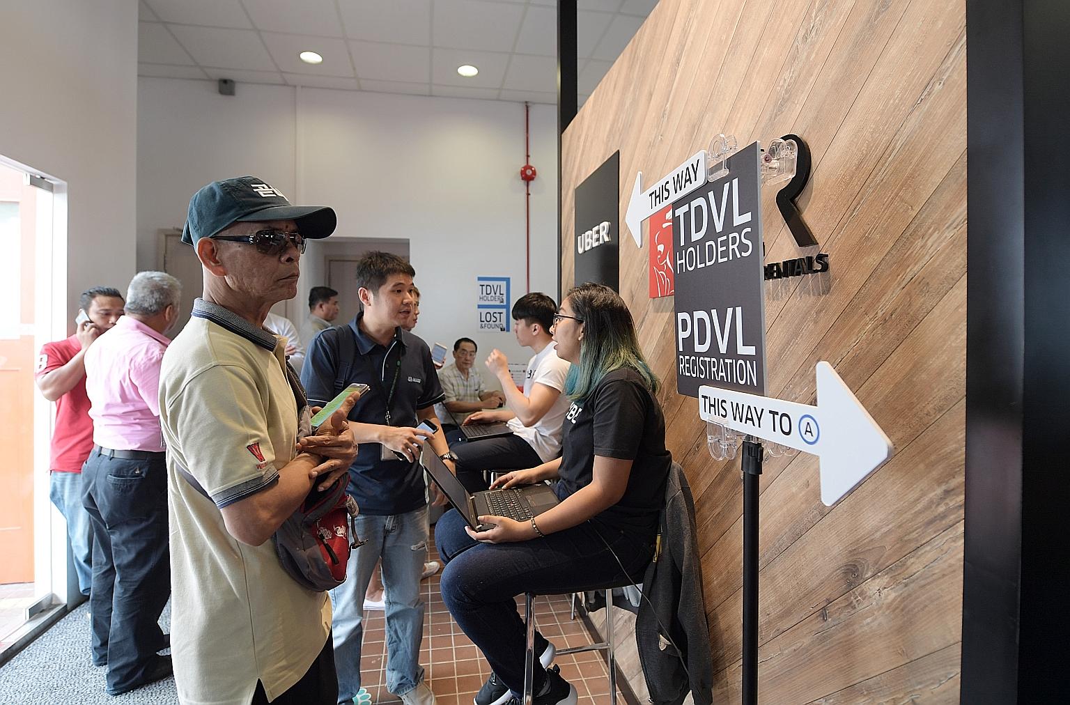 Applicants for the mandatory Private Hire Car Driver's Vocational Licence at UberHub in Paya Lebar in June last year. A one-year concession period was given for them to pass the test for the licence.