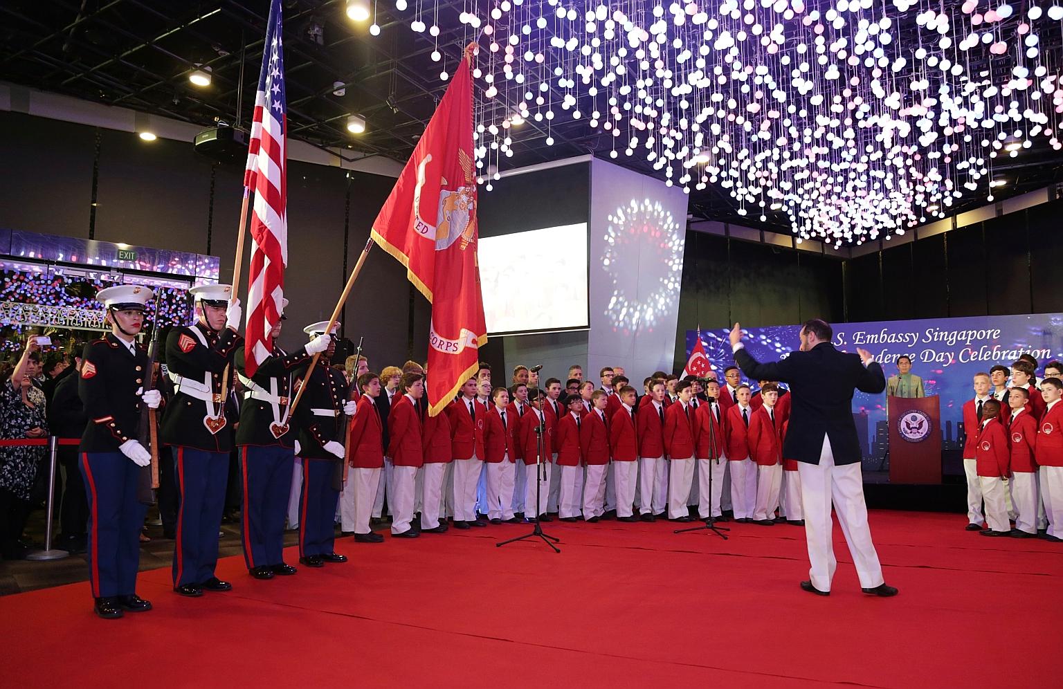 United States Marines yesterday during the Presenting Of The Colours ceremony as the world-renowned Philadelphia Boys Choir sang the US and Singapore national anthems at the celebration of the 242nd anniversary of the United States' independence, whi
