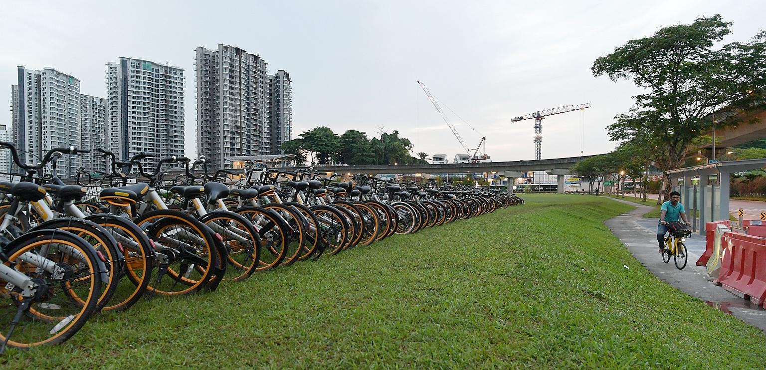 Rows of oBikes spotted at a field in Seng Kang early on Wednesday last week. Observers say the current dockless bike-share system - in which companies flood the market with two-wheelers and charge below-cost rates - is unsustainable.