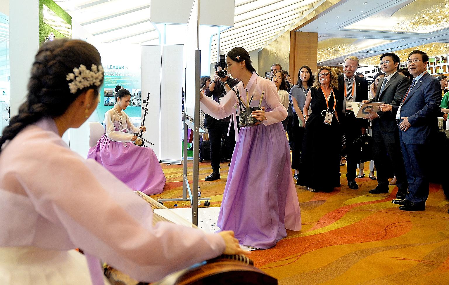 (From far right) Seoul Mayor Park Won-soon, National Development Minister Lawrence Wong and other guests on a tour of the Seoul booth on the first day of the World Cities Summit yesterday. Mr Wong said developments in innovation and infrastructure, i