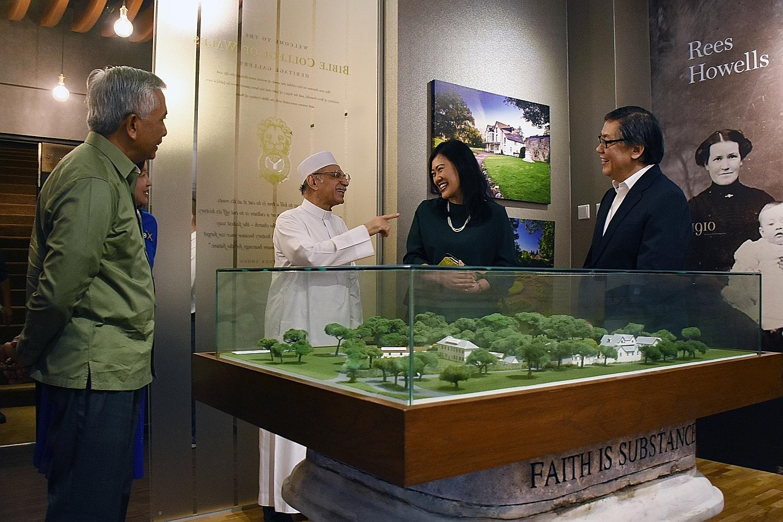From left: Mr Hawazi Daipi, Imam Habib Hassan Al-Attas, Ms Katharyn Peh and Pastor Yang Yuck Yoong looking at a model of the Bible College of Wales during the Ba'alwie Mosque delegation's visit to Cornerstone Community Church yesterday.
