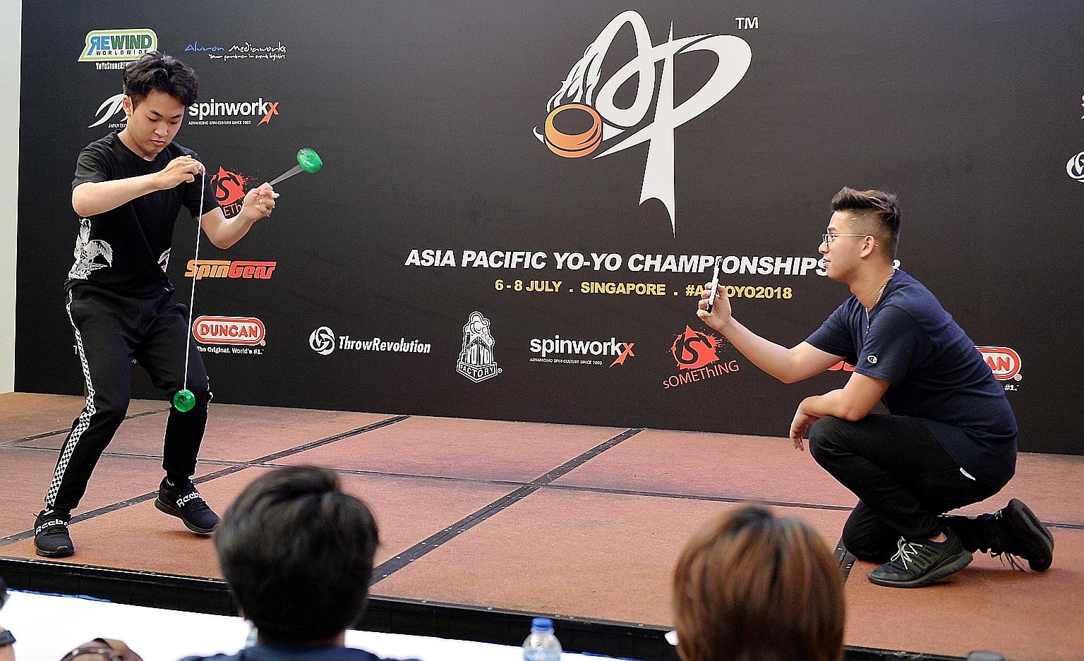 Champion of Champions Arata Imai (left) doing his tricks yesterday, with his performance recorded by Mr Thawrir Iqbal using a phone. The competition drew 161 competitors from 15 countries in the region.