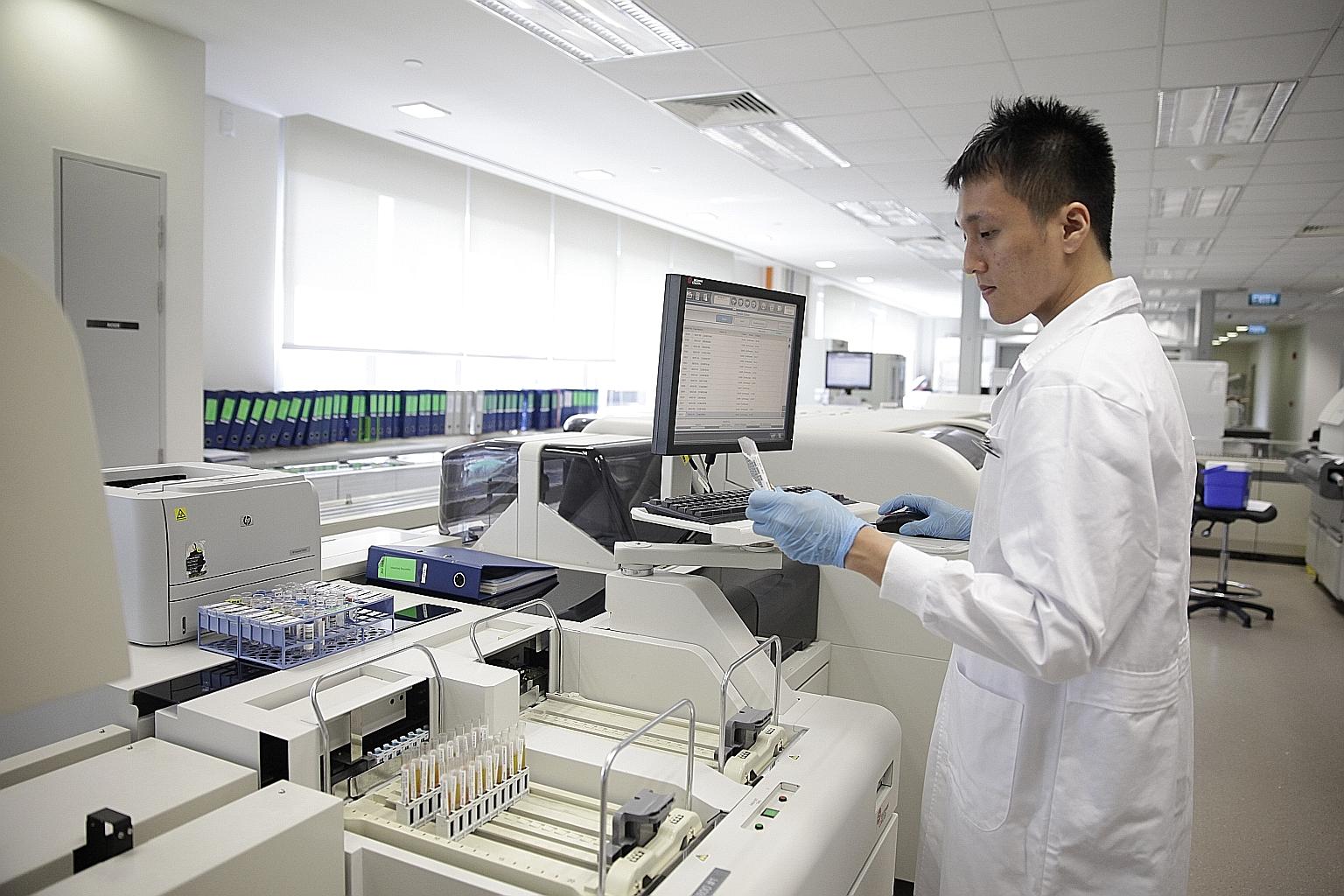 Medical lab technologist Su Jun Qiang, 27, verifying a glucose test result at the Clinical Biochemistry Laboratory under Singapore General Hospital's Department of Clinical Pathology.