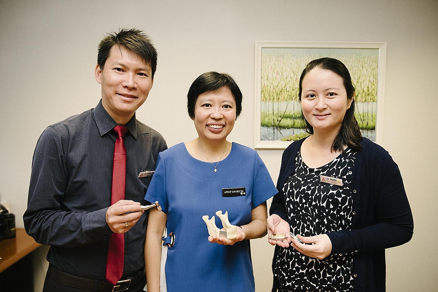 National Dental Centre Singapore researchers (from left) Dr Edwin Liu, Dr Goh Bee Tin and Dr Liu Yuchun with a mock-up of the new device.