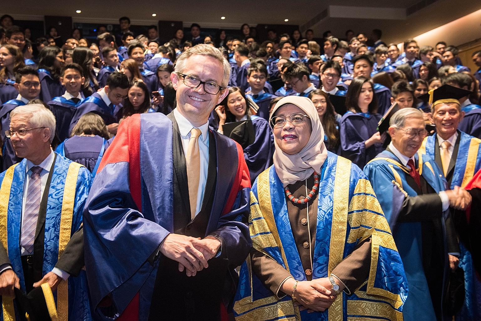 President Halimah Yacob shares a photo with Professor Simon Chesterman, dean of NUS Faculty of Law. About 360 law graduates were conferred their degrees at the ceremony yesterday. The ceremony was Madam Halimah's first since she became the university