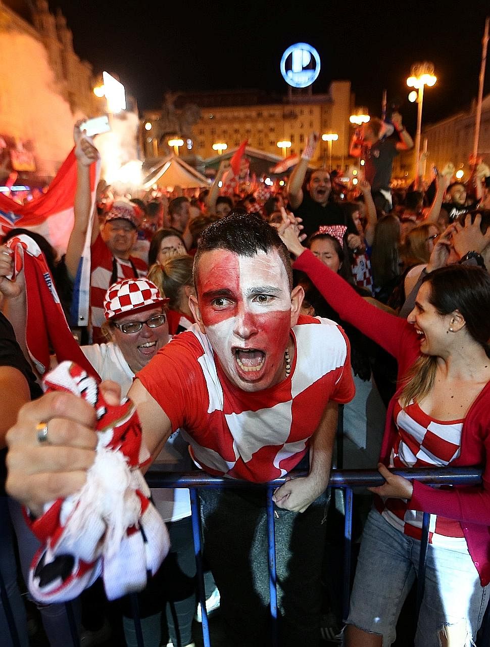 Croats painting the town red - and white - as they go wild in celebration after their country beat England 2-1 in extra time on Wednesday to qualify for the World Cup final for the first time.